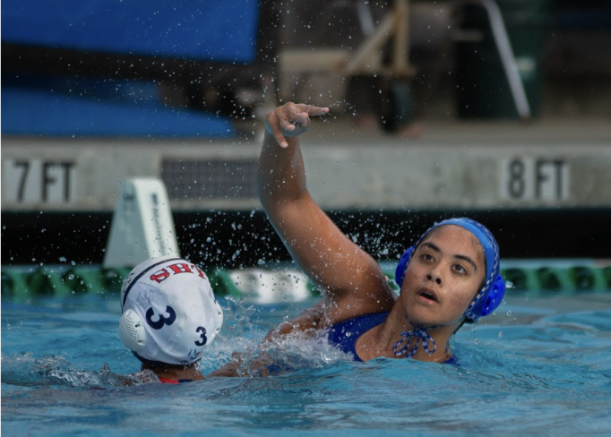 Senior Carmen Chao throws water polo ball to a teammate against Lynbrook High School. The varsity girls water polo team has a league record of 12-2.